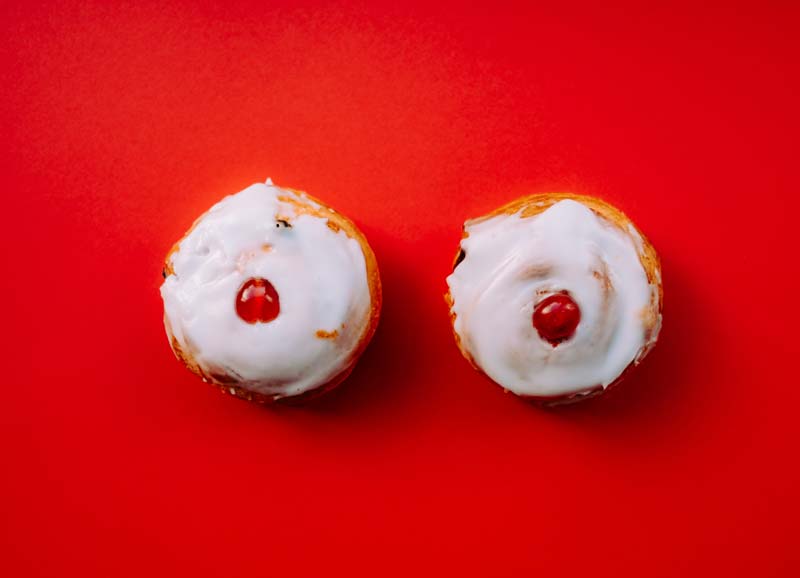 Cupcakes with cherries on them that look like breasts